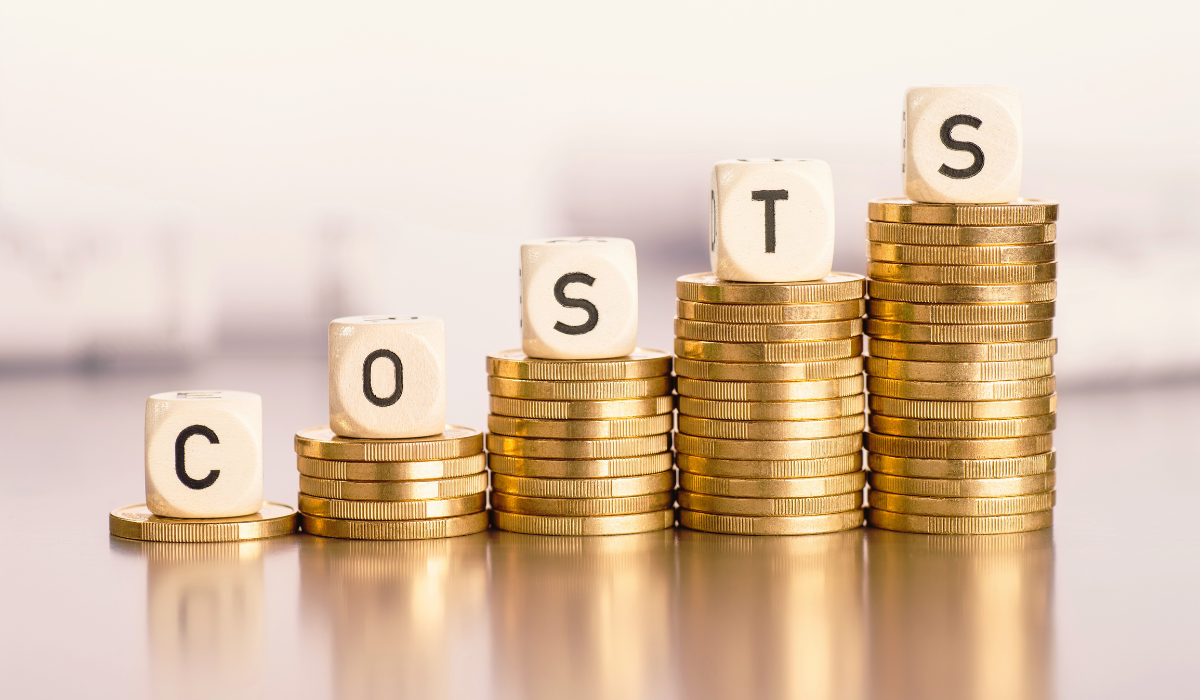 Stacks of gold coins increasing in height with wooden blocks on top spelling "COSTS" for blog pillar How to Immigrate to Australia from South Africa
