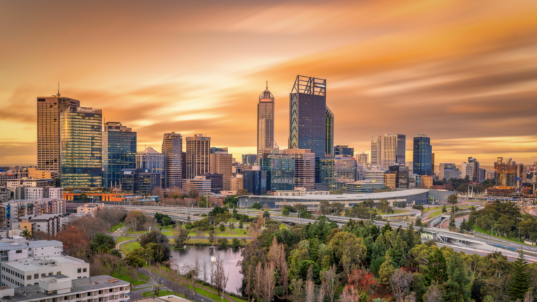 Golden hued sky at sunset with the city scape of Perth for blog Qualifications for Migrating to Australia